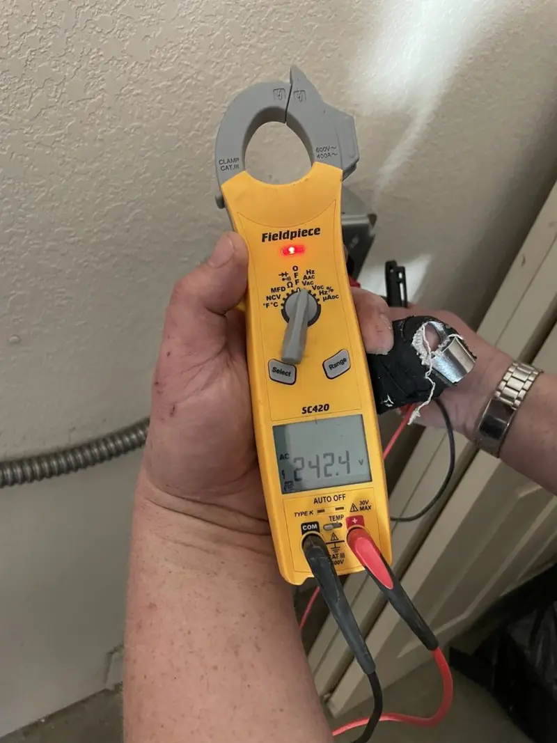 Voltage testing with clamp meter during Recessed Lighting Installation in Dyer